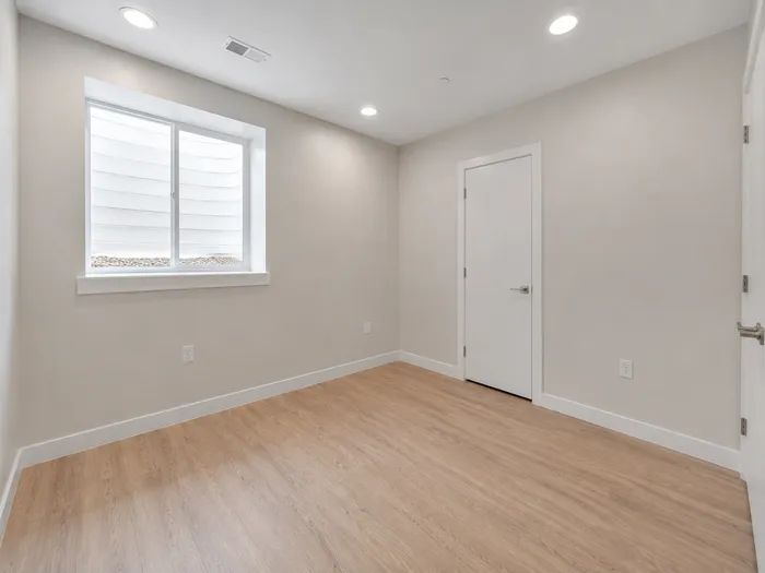 Basement bedroom with window well window and closet