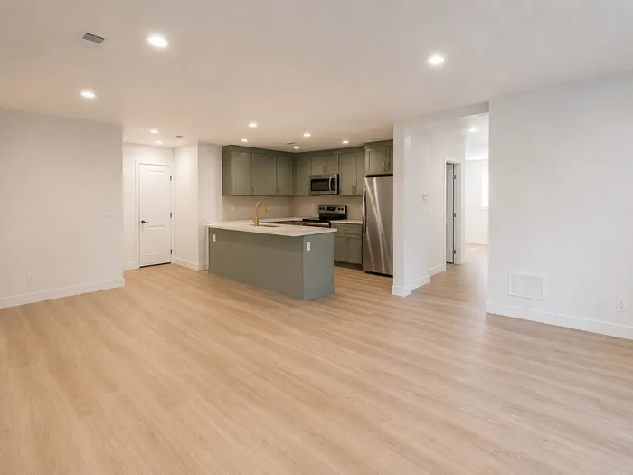 Open basement family area beside the sage kitchenette